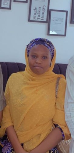 A professional headshot of Khadija Goni